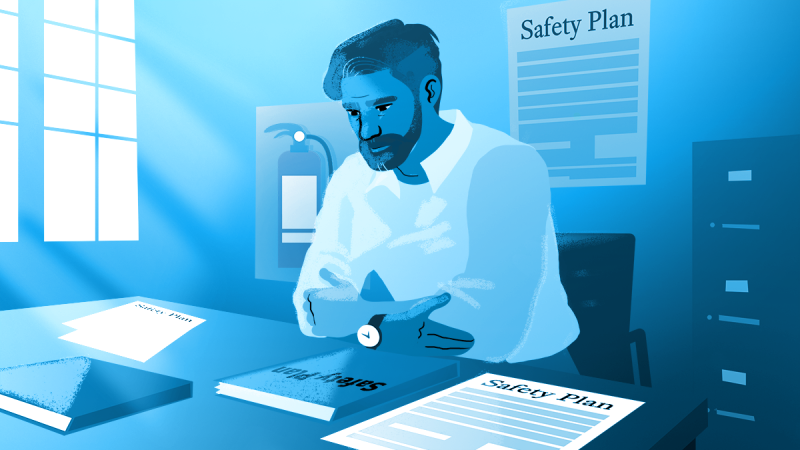 A man sitting at a desk working on Safety Plans