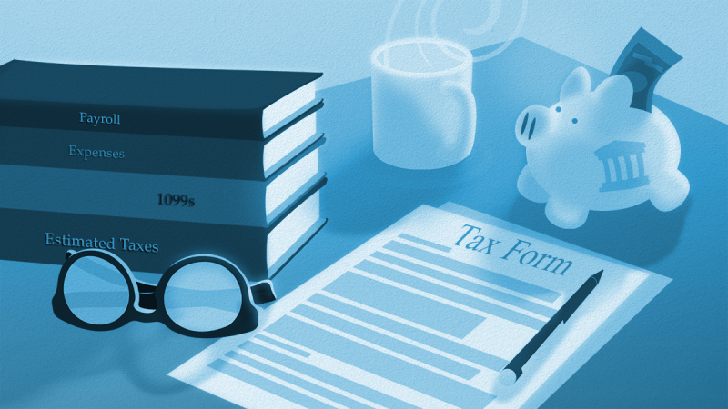 tax preparation documents and a piggy bank on a desk