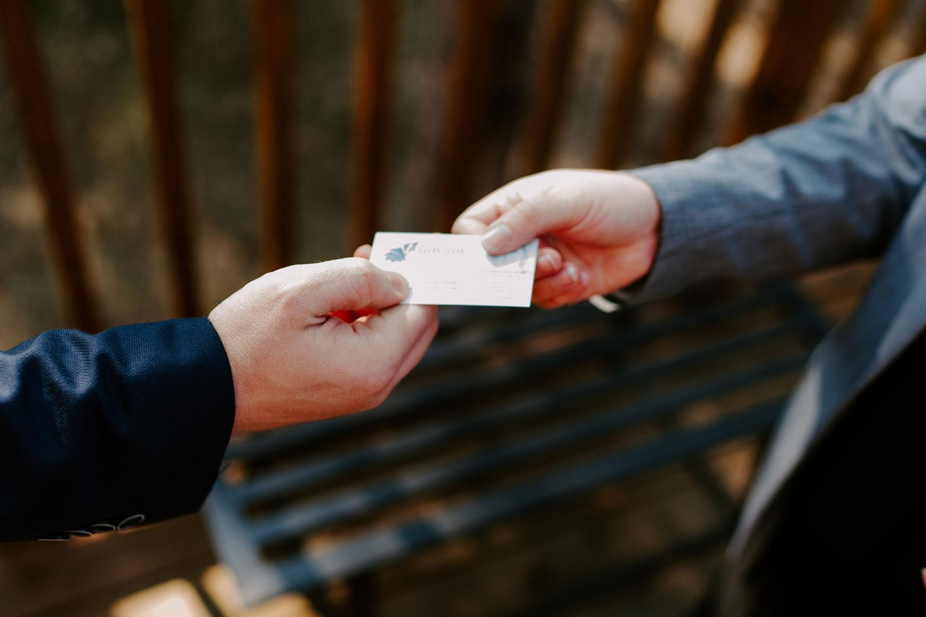 Two people exchanging a business card