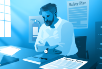 A man sitting at a desk working on Safety Plans