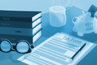 tax preparation documents and a piggy bank on a desk